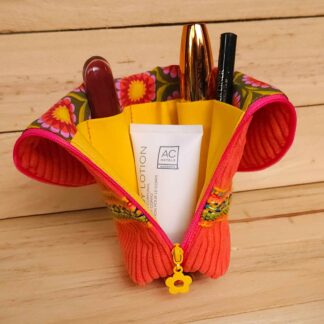 trousse orange ouverte avec compartiments et maquillage